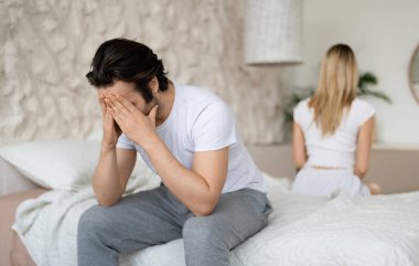 İlişki krizi. Beyaz bir adam karısıyla kavga ettikten sonra üzgün hissediyor, evde sırt sırta oturuyor. Kavga ettikten sonra birbirini görmezden gelen çift boşanmayı düşünüyor.