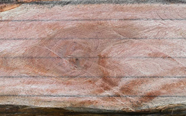 Overhead view of a flattened smooth wood surface which is marked to get wood planks