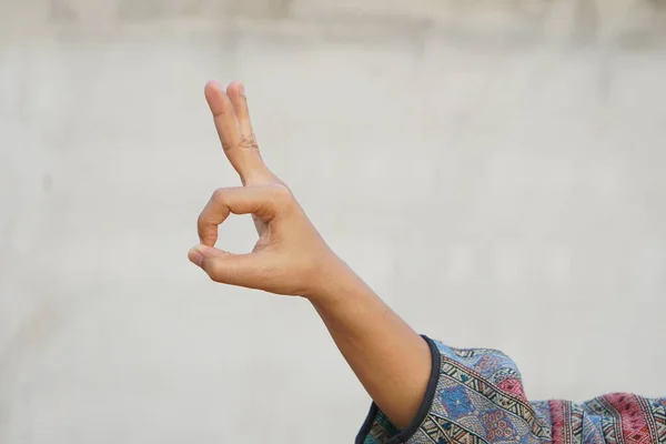 Woman doing hand gestures as a sign of ok