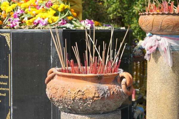 Clay pots with many incense sticks to worship the Buddha