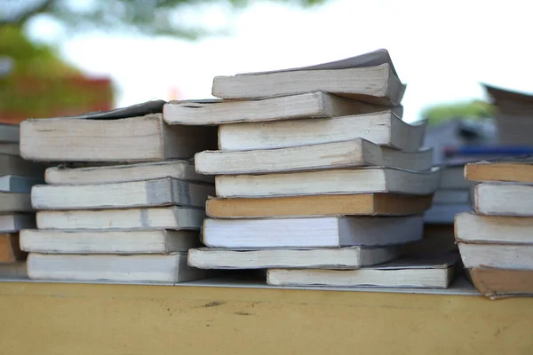 Stacks of old books waiting to be recycled.