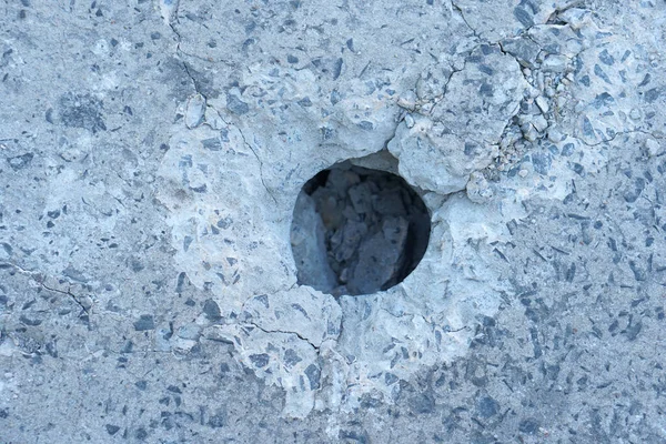 Holes are made by drilling from a machine for repairing concrete roads.