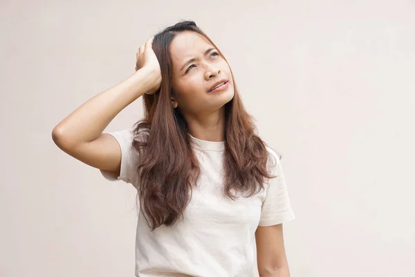 Asian women suffer from work stress. Put your hand on your head