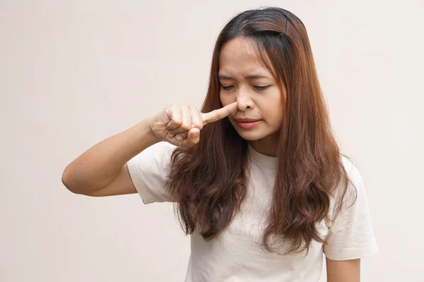 Asian women cover their noses with their hands because they smell bad.