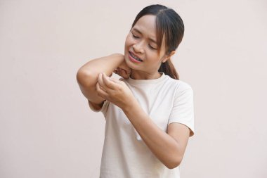 Asian woman having an itchy arm