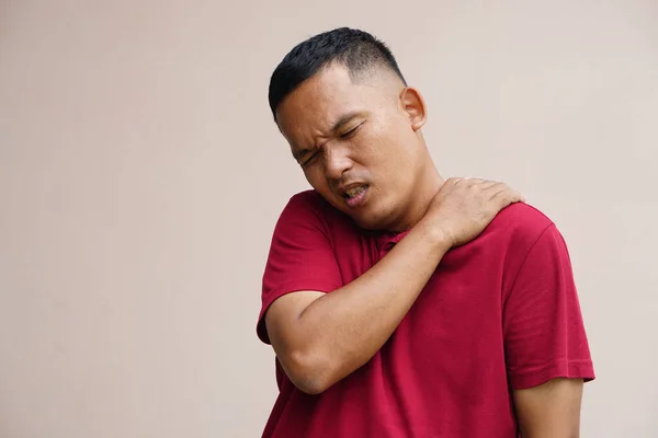 Asian man with shoulder pain