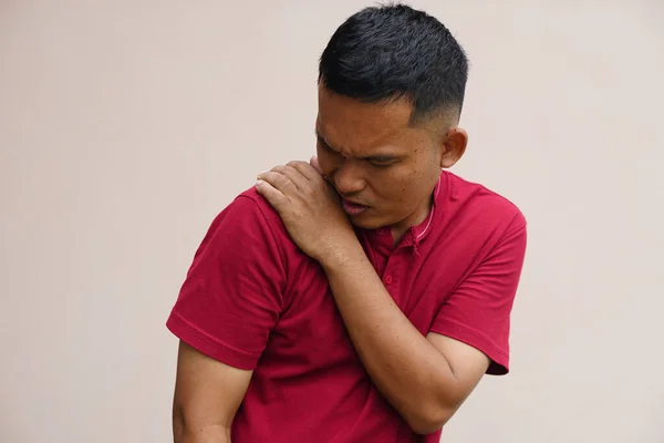 Asian man with shoulder pain