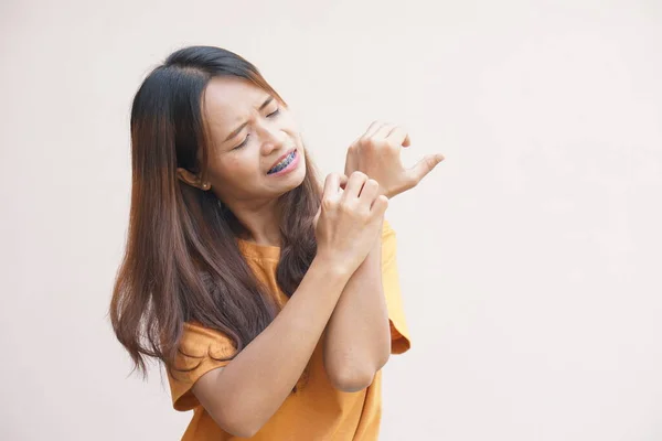 Asian woman having itchy skin on hands