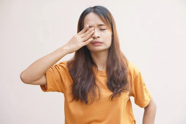 Asian woman having pain in the eye area