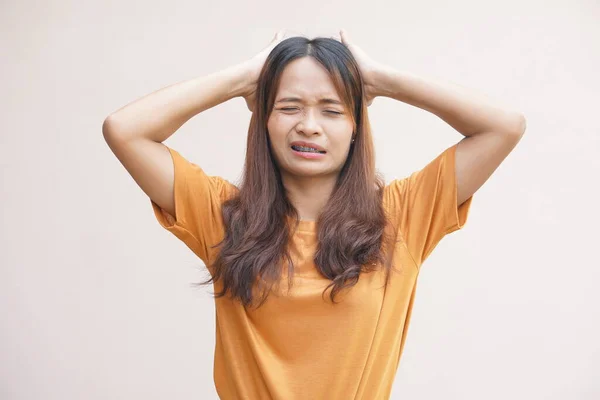 Asian women suffer from headaches from thinking about work.