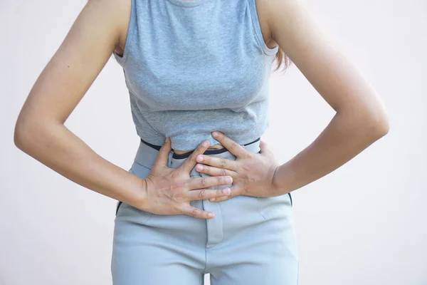 stock image Asian woman having stomach pain from stomach disease not eating on time	