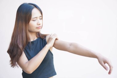 Asian woman having shoulder pain.