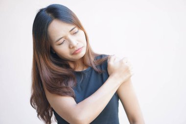 Asian woman having shoulder pain.