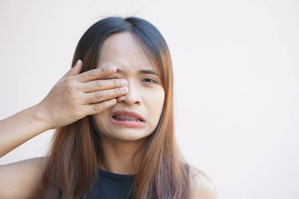 Woman having pain in the eye area