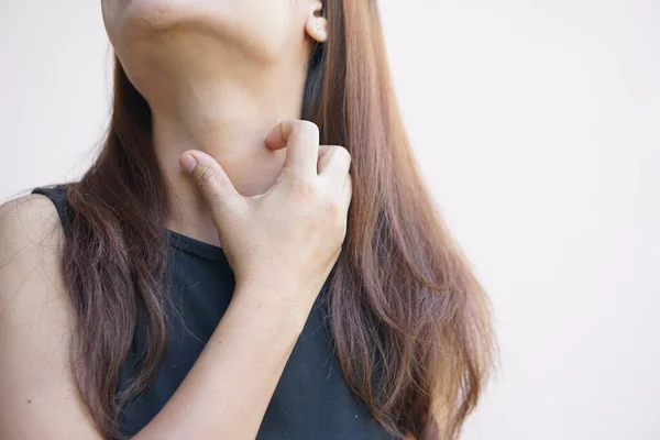 Woman having itchy skin on the neck