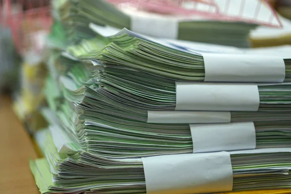 Paper stack on the desk related to business functions. With morning light,soft focus