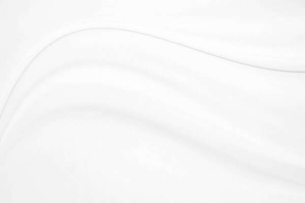 Гладкий элегантный белый шелк или атласная текстура роскошной ткани может использоваться в качестве свадебного фона. Роскошный дизайн фона