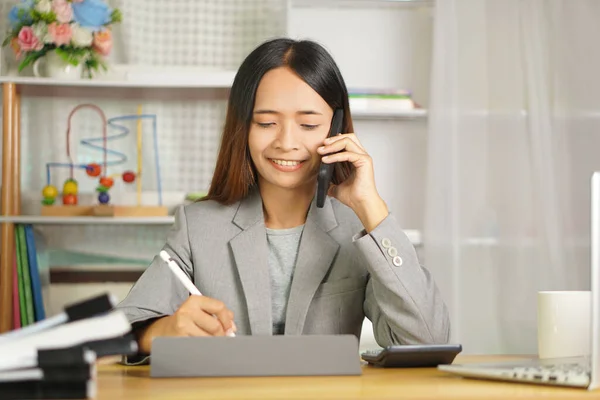 Businesswoman contacting customers by phone