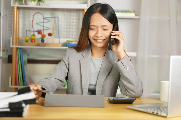 Businesswoman contacting customers by phone