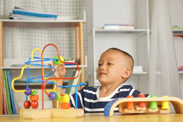 Boy Plays Developmental Toys Table House Sliding Ball Curved Steel — Stock Photo, Image