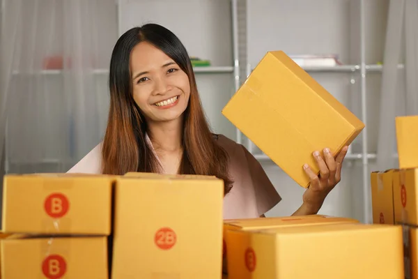 Online sellers check product boxes before delivering to customers.