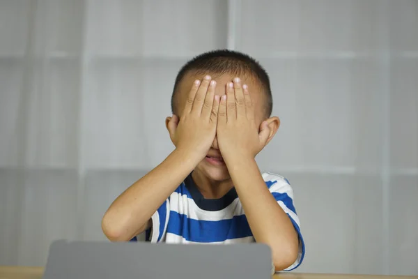 stock image Boy has eye strain from looking at computer for a long time