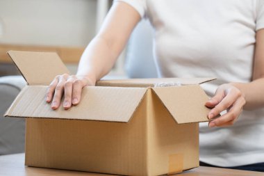 person unboxing package shopping online via internet at home