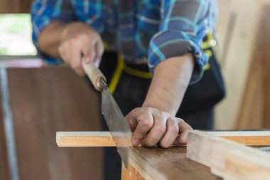 Hands of person doing diy project at home. Man measuring wood to doing cabinet craftworks as a hobby.