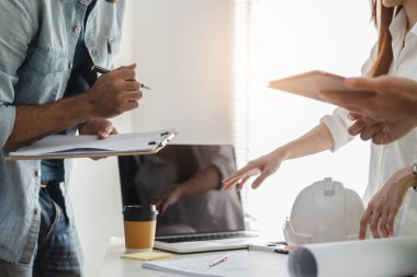 Engineer / contractor team brainstorming to design a room layout for project reconstruction house.