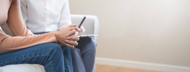 Young woman in a mental therapy session talking with a psychologist in the office.