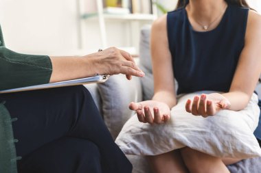 female have a conversation in a depressed therapy session with psychologist in office