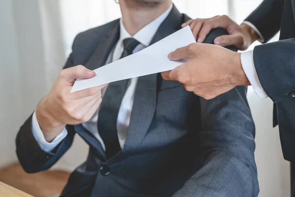 Close up view of boss giving commission bonus to office worker.