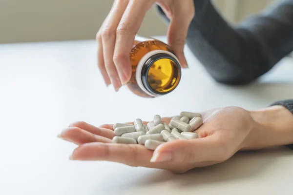 close up hand of young women. Stressed female taking drug overdose.