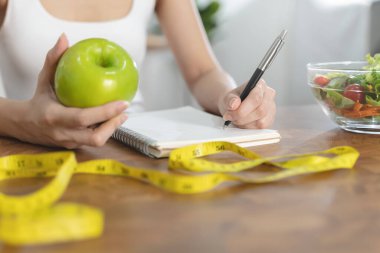 person take note of weight and counting of calories to eat in each day