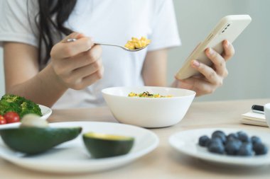 young female planning menu to eat ketogenic diet during weight loss program.