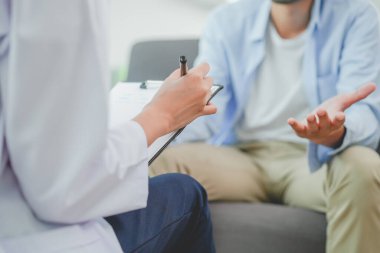 Men talk with a psychologist during talking therapy stressed mental health at office