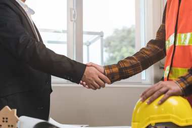 client and suppliers shaking hands after deal agreement completed.