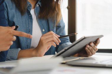 Close up finance advisor pointing into computer screen.