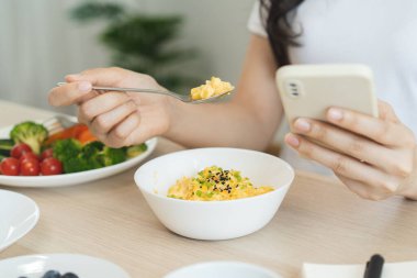 young female planning menu to eat ketogenic diet during weight loss program.