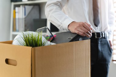 businessman packing stuff after resigned