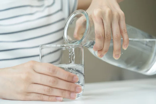 Clean freshwater concept. Woman drink mineral water in the morning for good health.