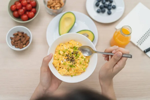 young female planning menu to eat ketogenic diet during weight loss program.