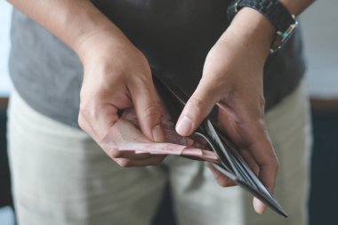 Man holding wallet with full of money prepare for spend.