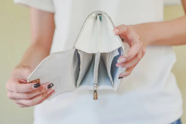 Broke financial. woman open her purse and do not have any money.