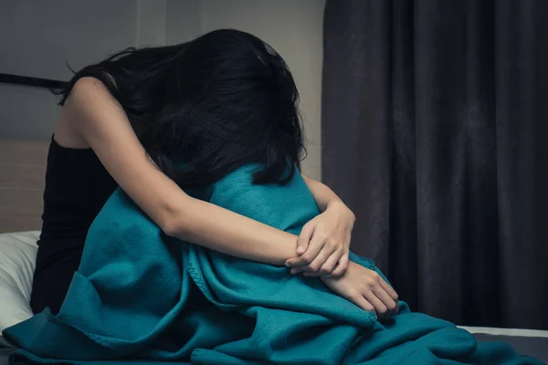 asian tyoung woman feeling depressed and lonely in the house.  Have acopy space for text.