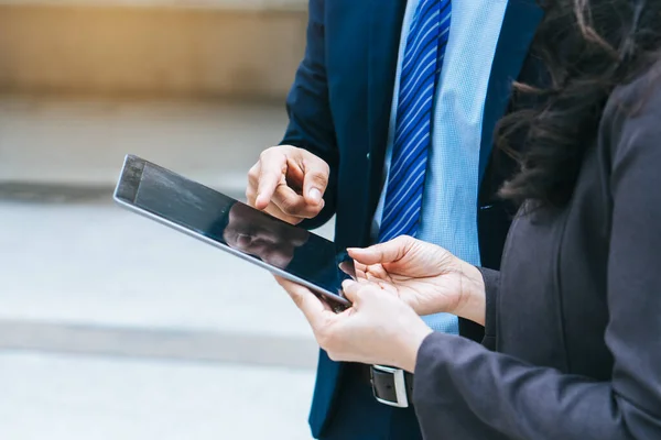 Modern gadget in business company. Businessman reviewing budget information in touchpad.