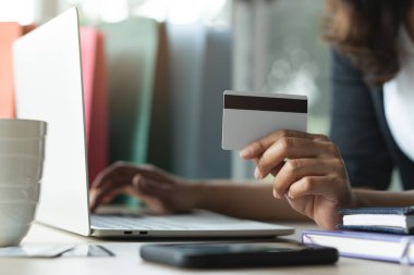 close up shots hands of person shopping on ecommerce and using credit card payment via online banking.