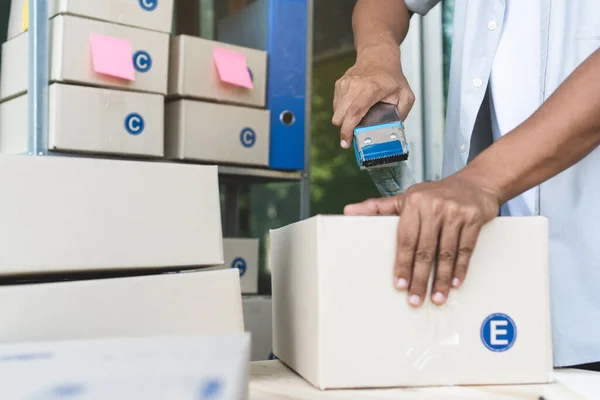 stock image close up view of ecommerce business owner preparing goods to  deliver to customer.