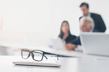 Close up shot glasses and laptop computer on the table in conference room.