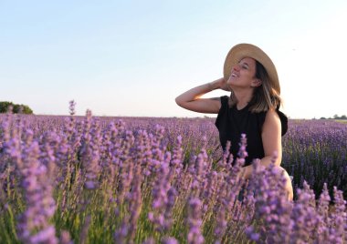 Happy woman breathing in a lavender field